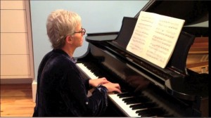 Robin Sloane Seibert plays at an upright piano
