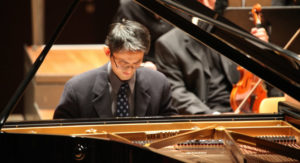 Amateur_pianist_Ricker_Choi playing an upright piano