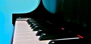 Up close piano keys with light blue background