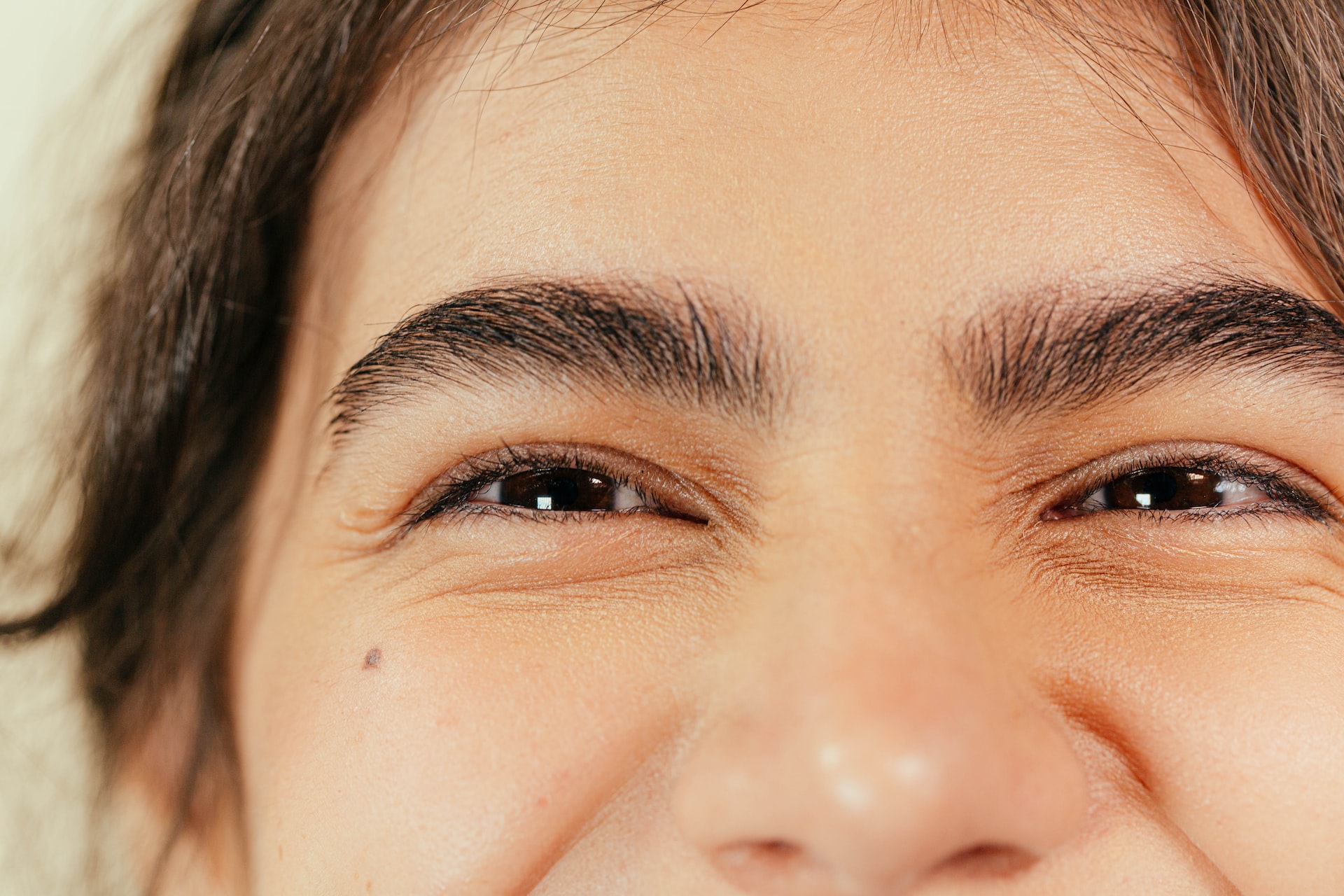 Close up of the top half of a woman's face, focusing on her eyes, which people miss with lip reading.